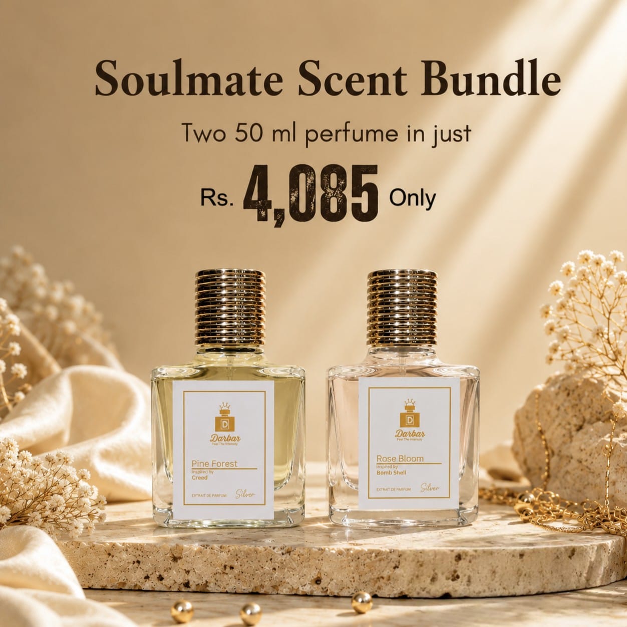 Two 50 ml perfume bottles from the Soulmate Scent Bundle by Ghandi are displayed on a stone slab with decorative dried flowers and draped fabric. The background is a warm beige with soft light rays, and promotional text at the top reads 'Soulmate Scent Bundle' and 'Rs.